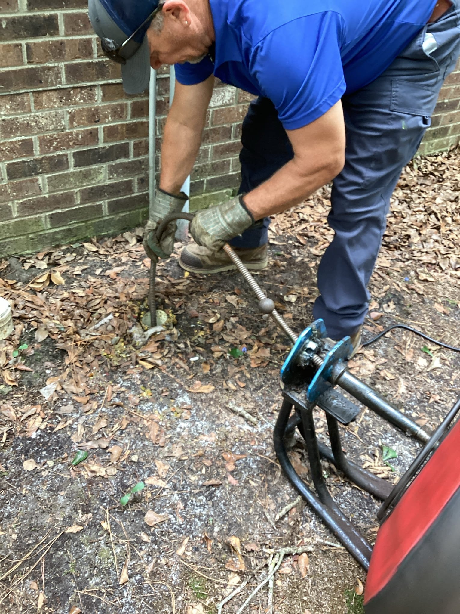 Professional plumber working on pipes